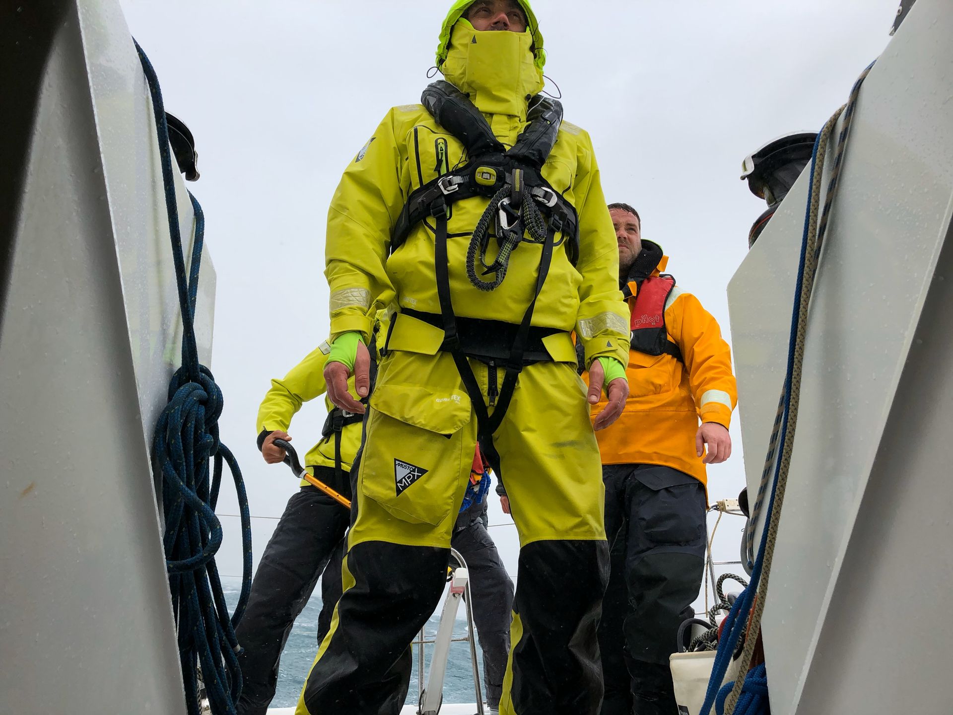 Professional yachtmaster in action with safety gear - hands-on sailing expertise